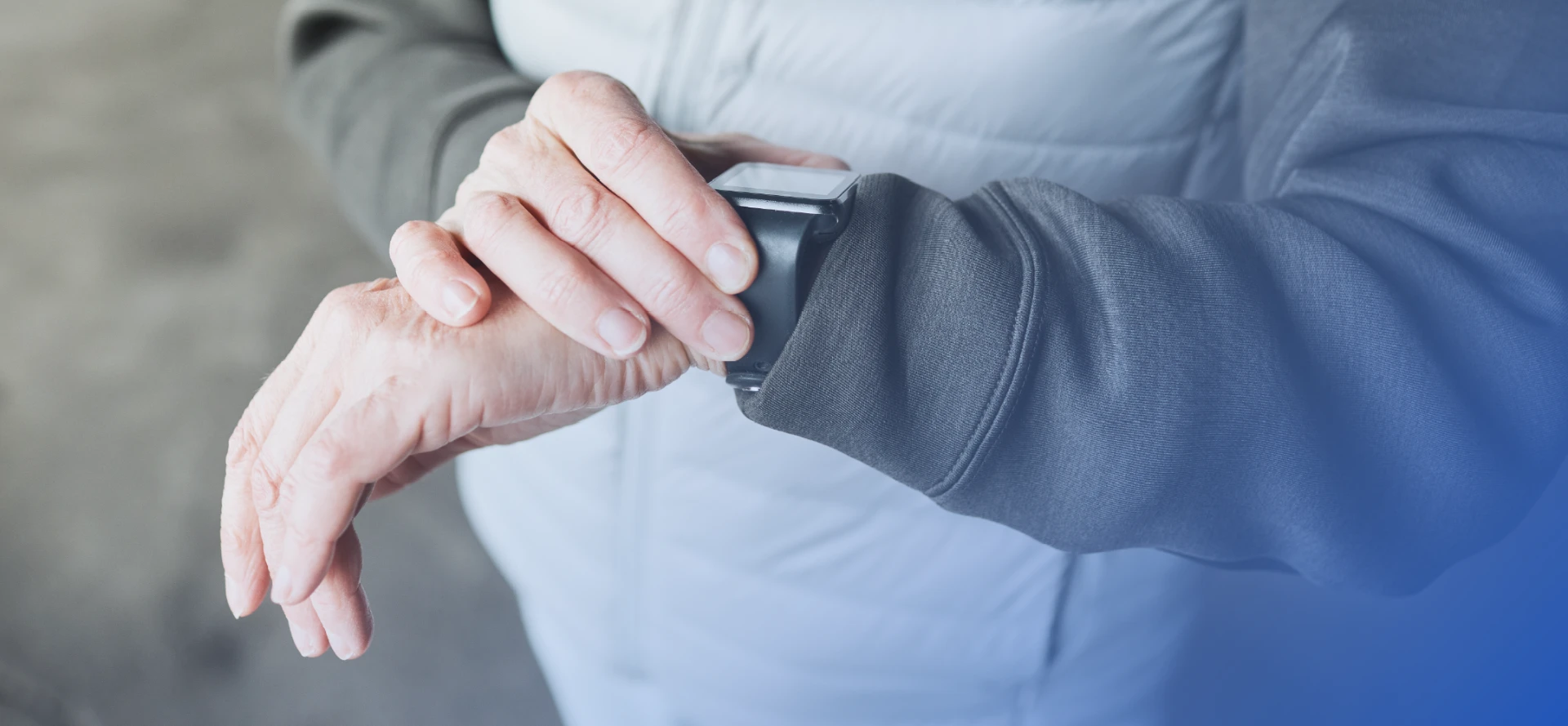 Close-up of a person in a winter jacket checking a smartwatch on their wrist